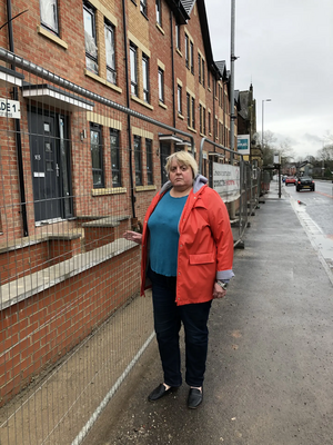 Jackie at the new houses fronting Hyde Road.