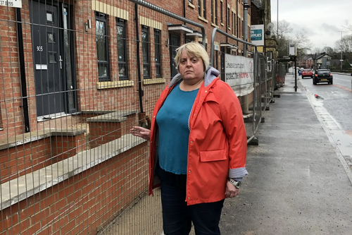 Jackie at the new houses fronting Hyde Road.