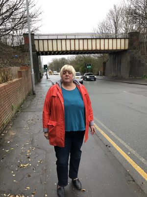 Image courtesy of By Charles Turner Jackie Pearcey at the Hyde Road Bridge to be demolished in the road widening.